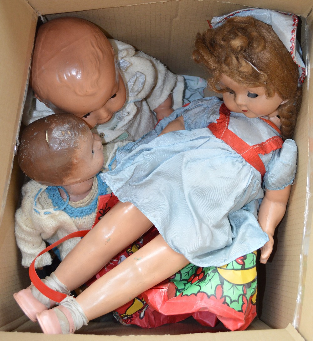 Three composition dolls and a quantity of folk dolls.