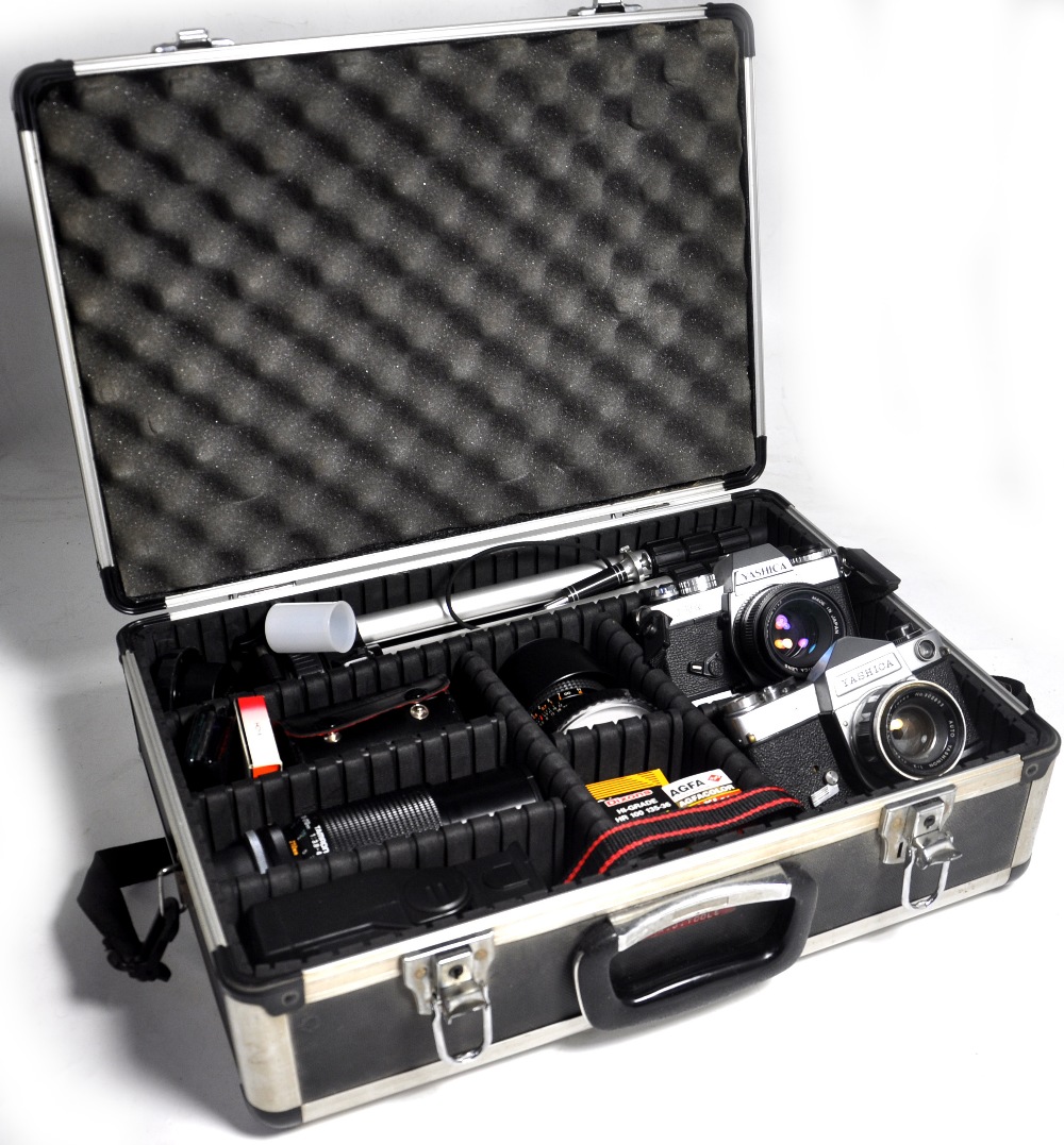An aluminium carrying case containing a photographic outfit comprising; Yashica FR, Yashica J-3,