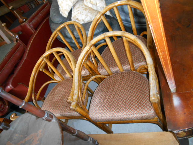 A Set of Four Bentwood Chairs with Cushioned Seats.