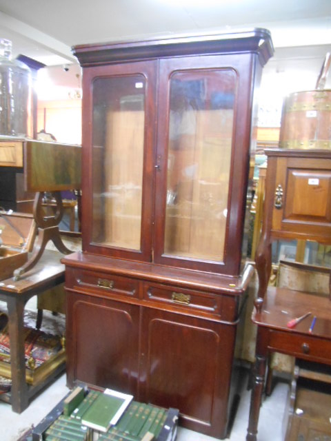 A Victorian Mahogany Bookcase with two glazed doors above drawers and cupboard doors (key in