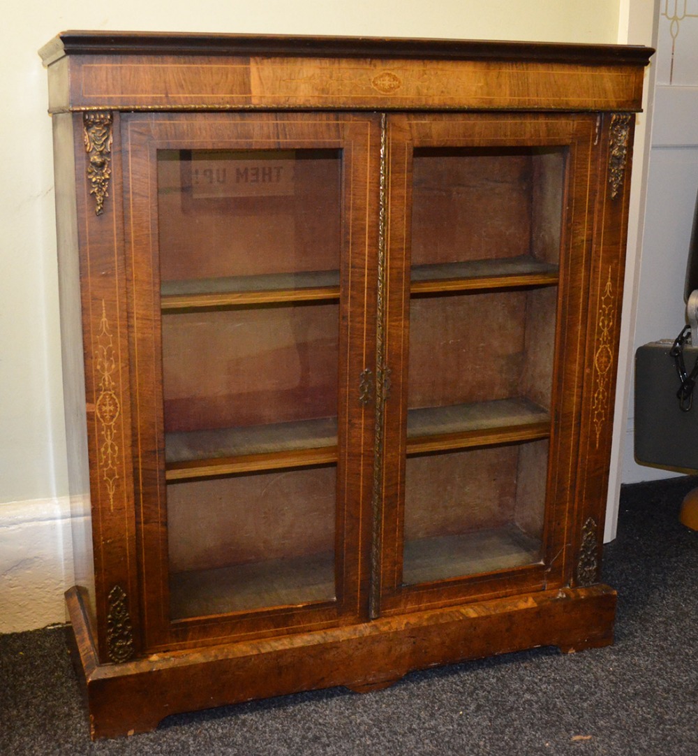 Victorian walnut bookcase base with satinwood inlay and brass scrolling.