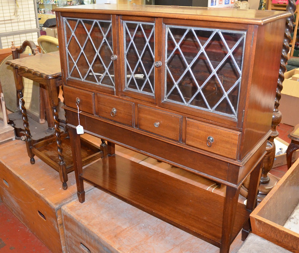 An oak, lead-glazed radio cabinet, together with a barleytwist side table.