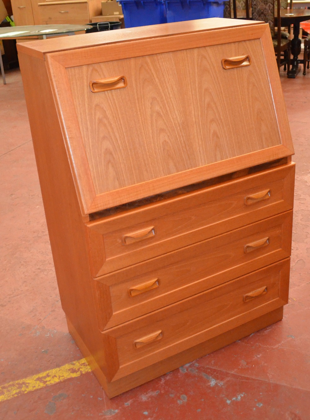 A G-Plan bureau with three drawers together with a Stag bookcase, lacking shelves.