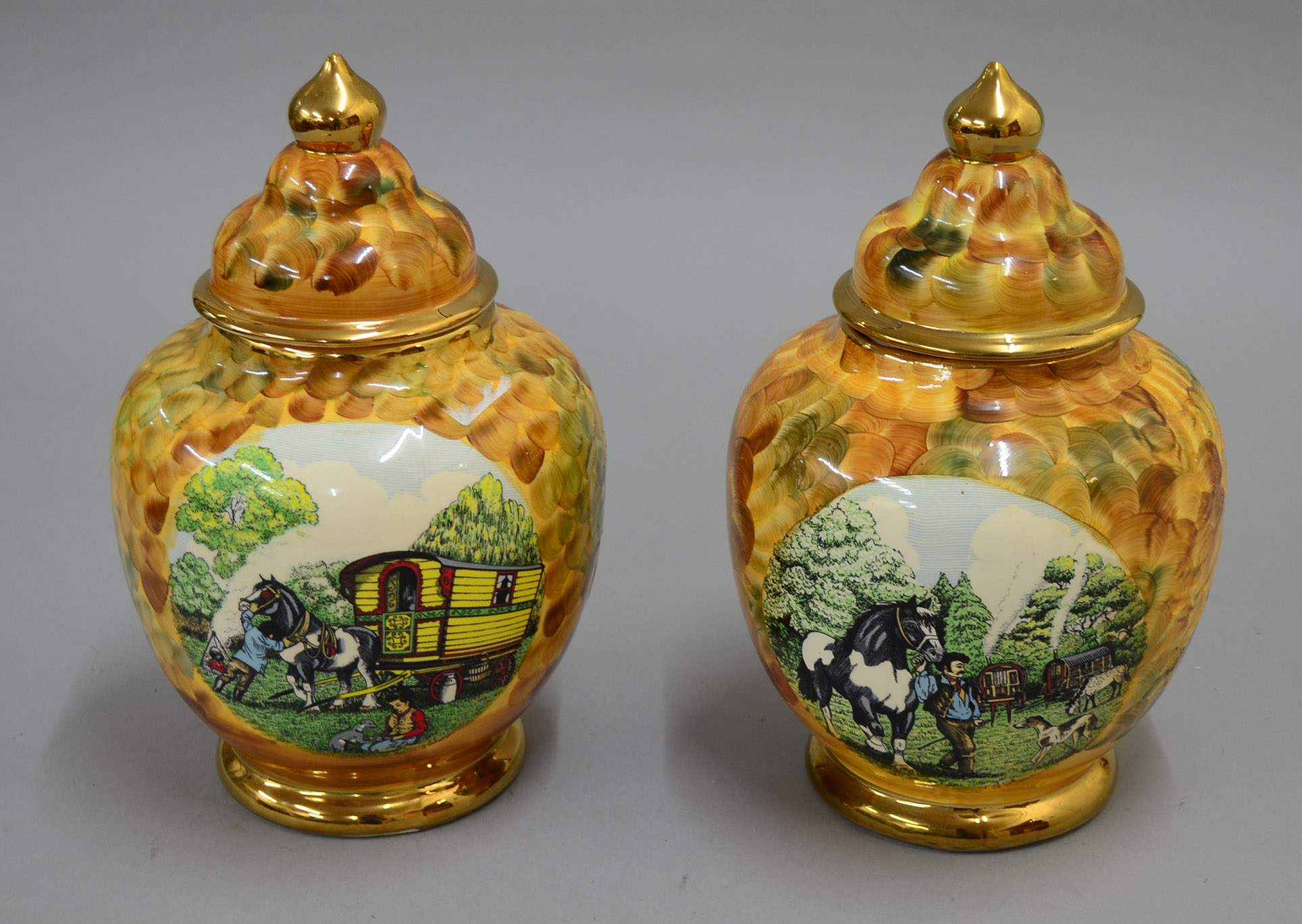 Impressive pair of Hose St. Pottery Tunstall porcelain lidded vases of bulbous form with gilding to