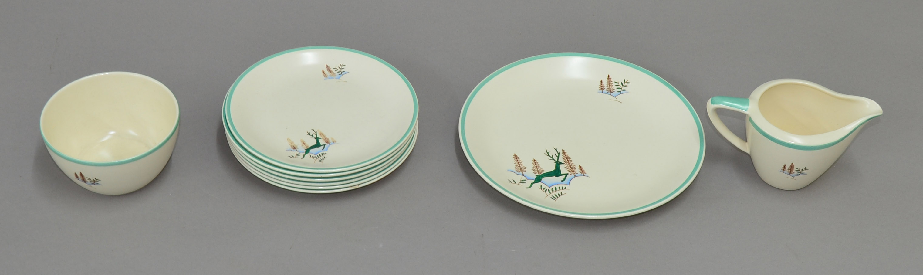 Nine pieces of Crown Devon china with turquoise banding and leaping stag decoration. Comprising six