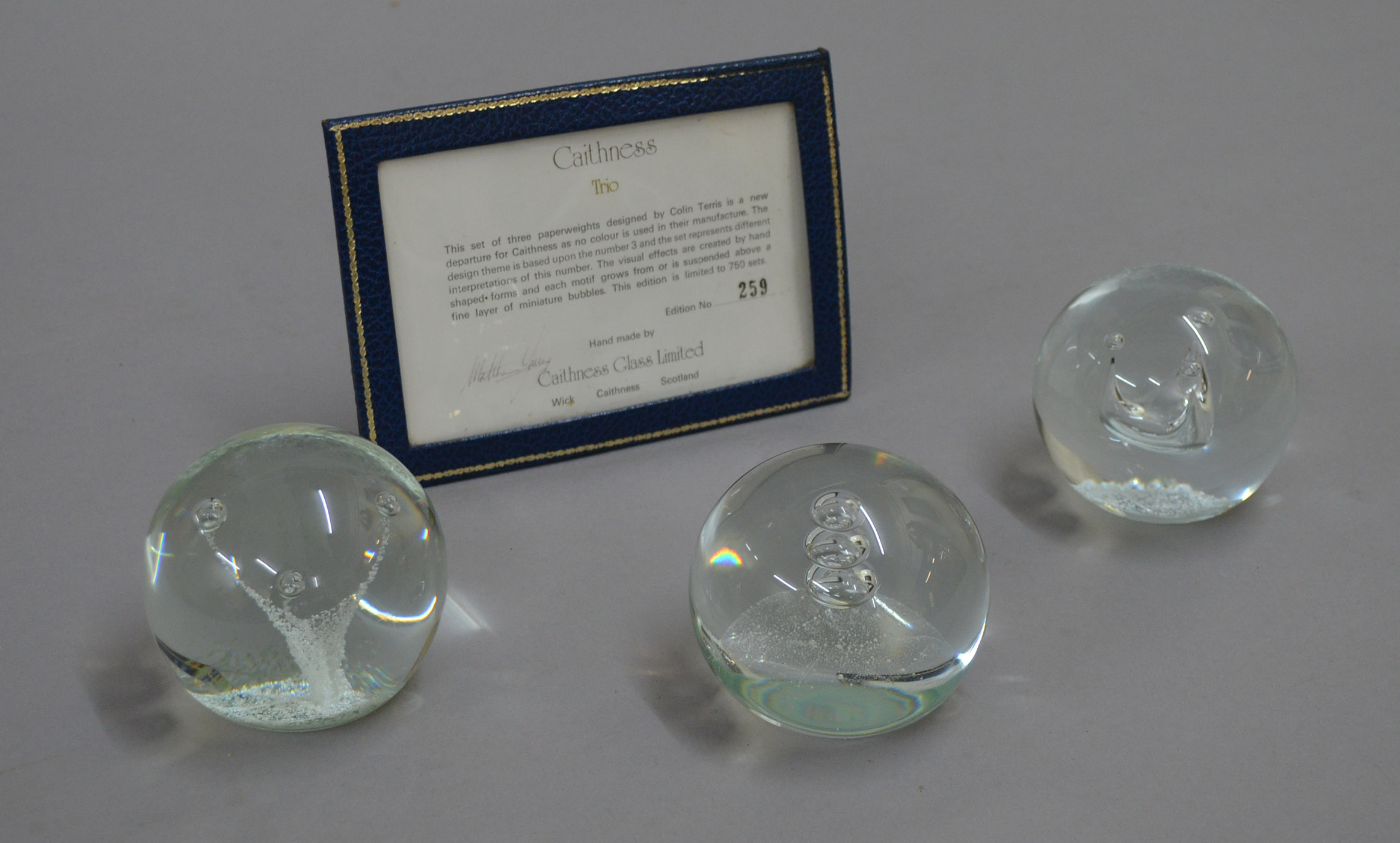 Set of colourless Caithness `Trio` paperweights, edition number 259, with certificate.