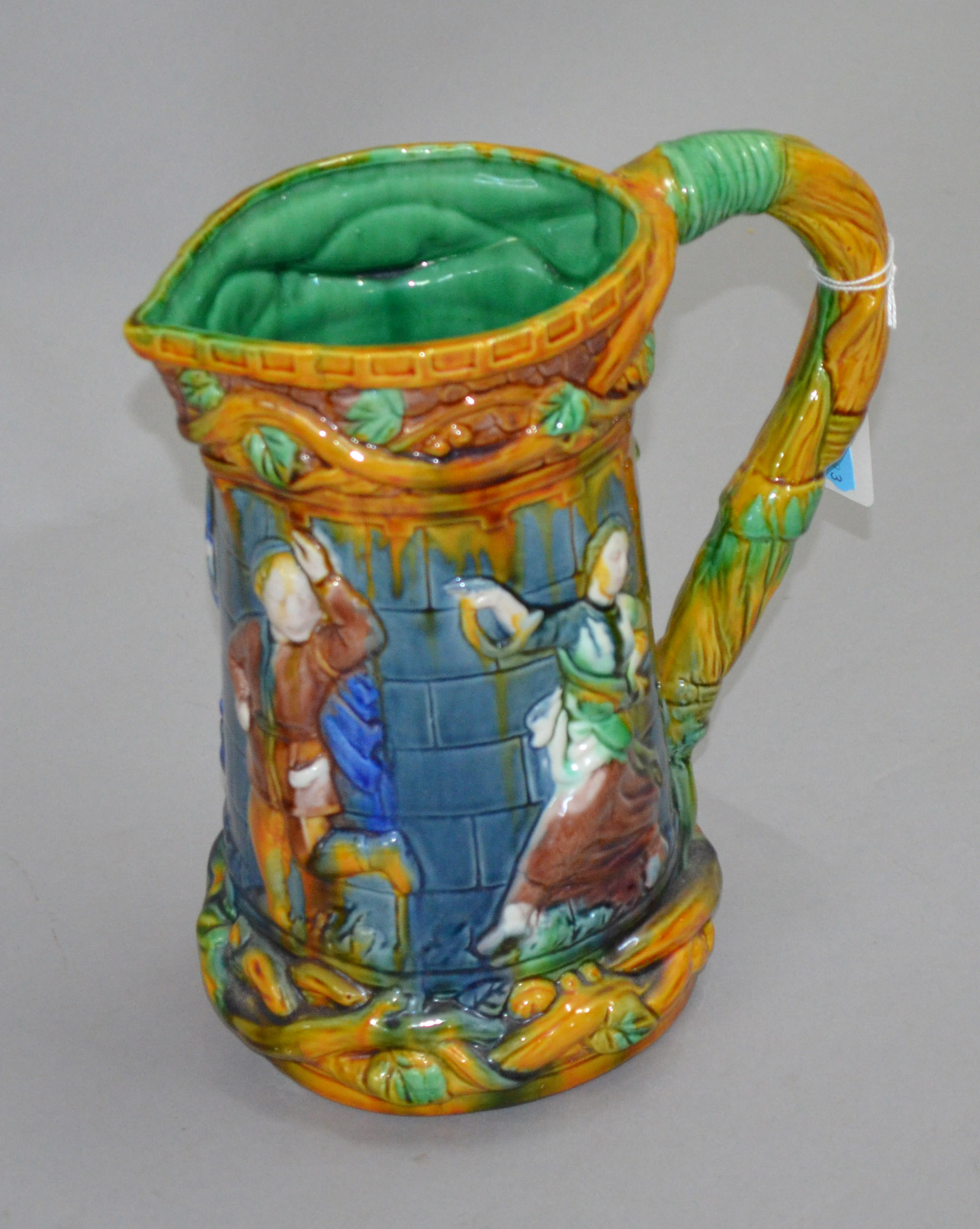 Large majolica jug decorated with dancers.