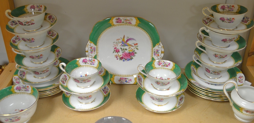 A twelve setting tea service, transfer decorated in a Bird of Paradise pattern, comprising twelve
