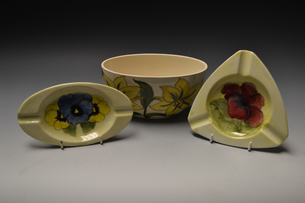 A Moorcroft pottery oval bowl, tubelined with yellow flowers, cream ground, a Hibiscus triangular