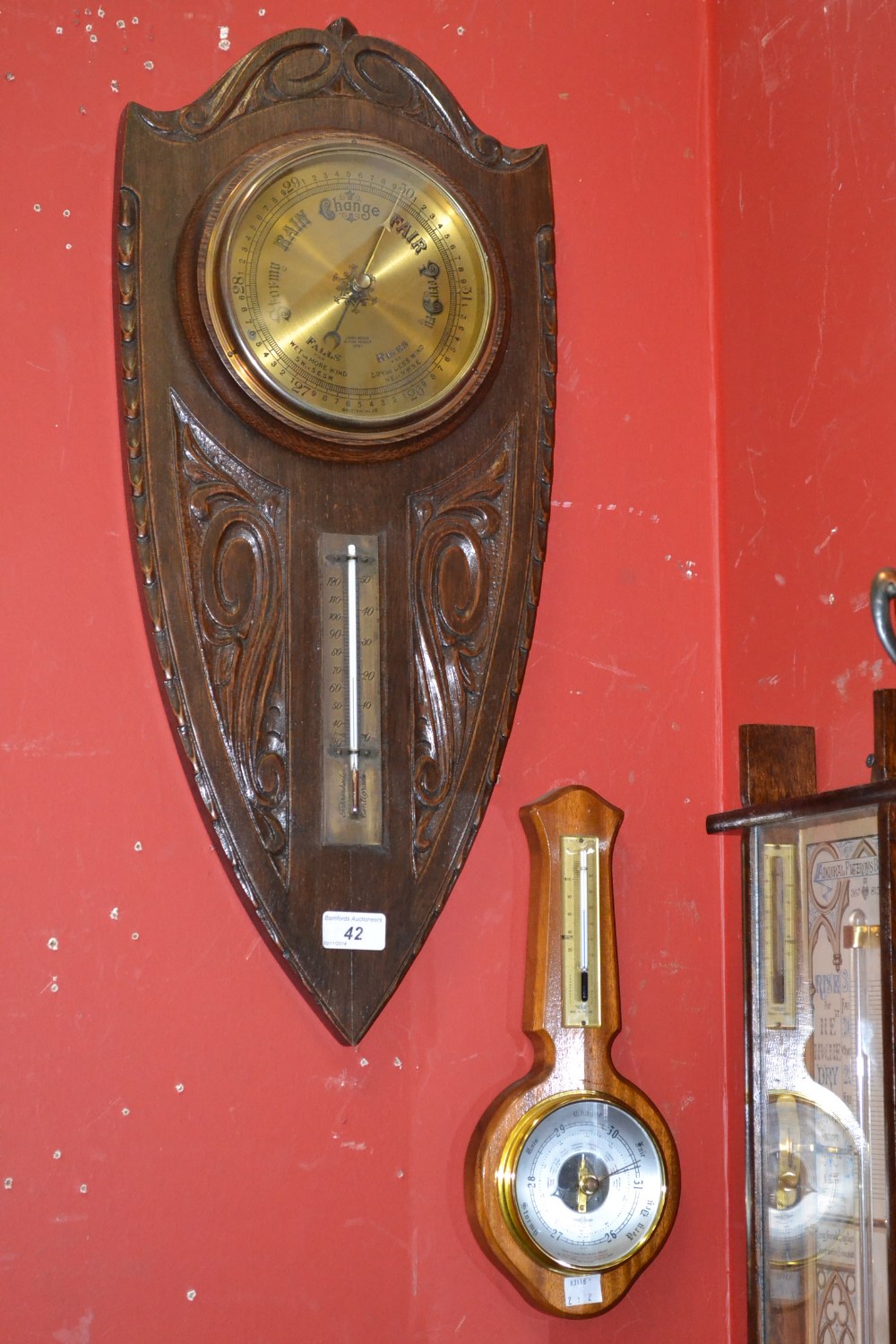 A shield barometer, James Moore of Derby; another modern barometer