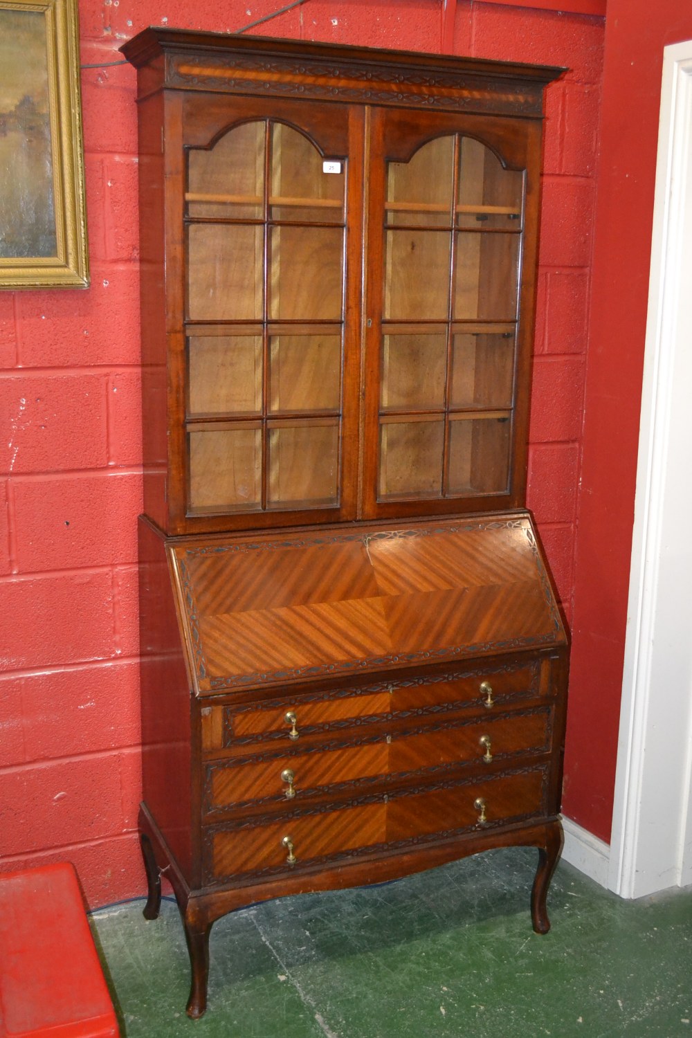 A 20th century mahogany bureau bookcase, carved pediment, glazed doors, fitted interior, three