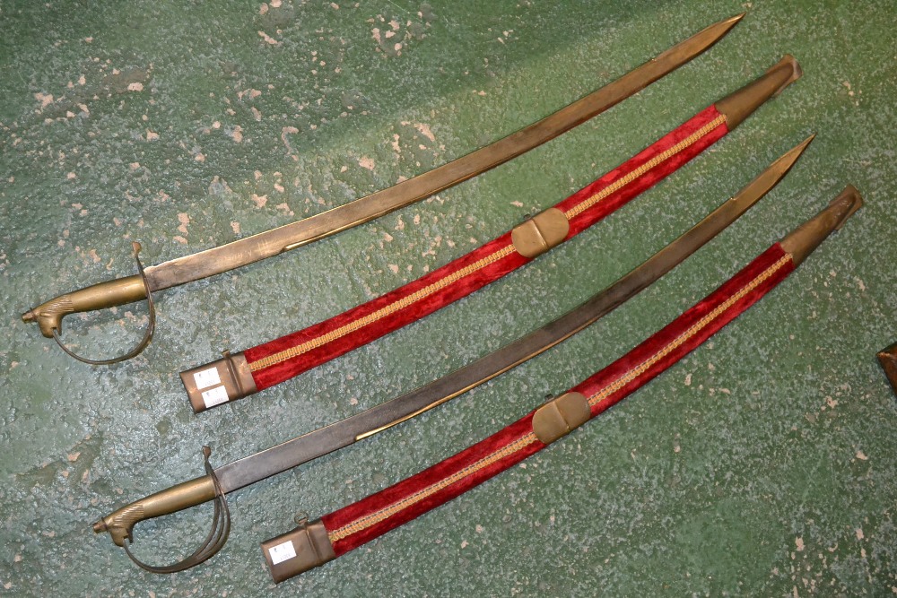 A pair of ceremonial dress swords, cast brass pommels, engraved steel blades