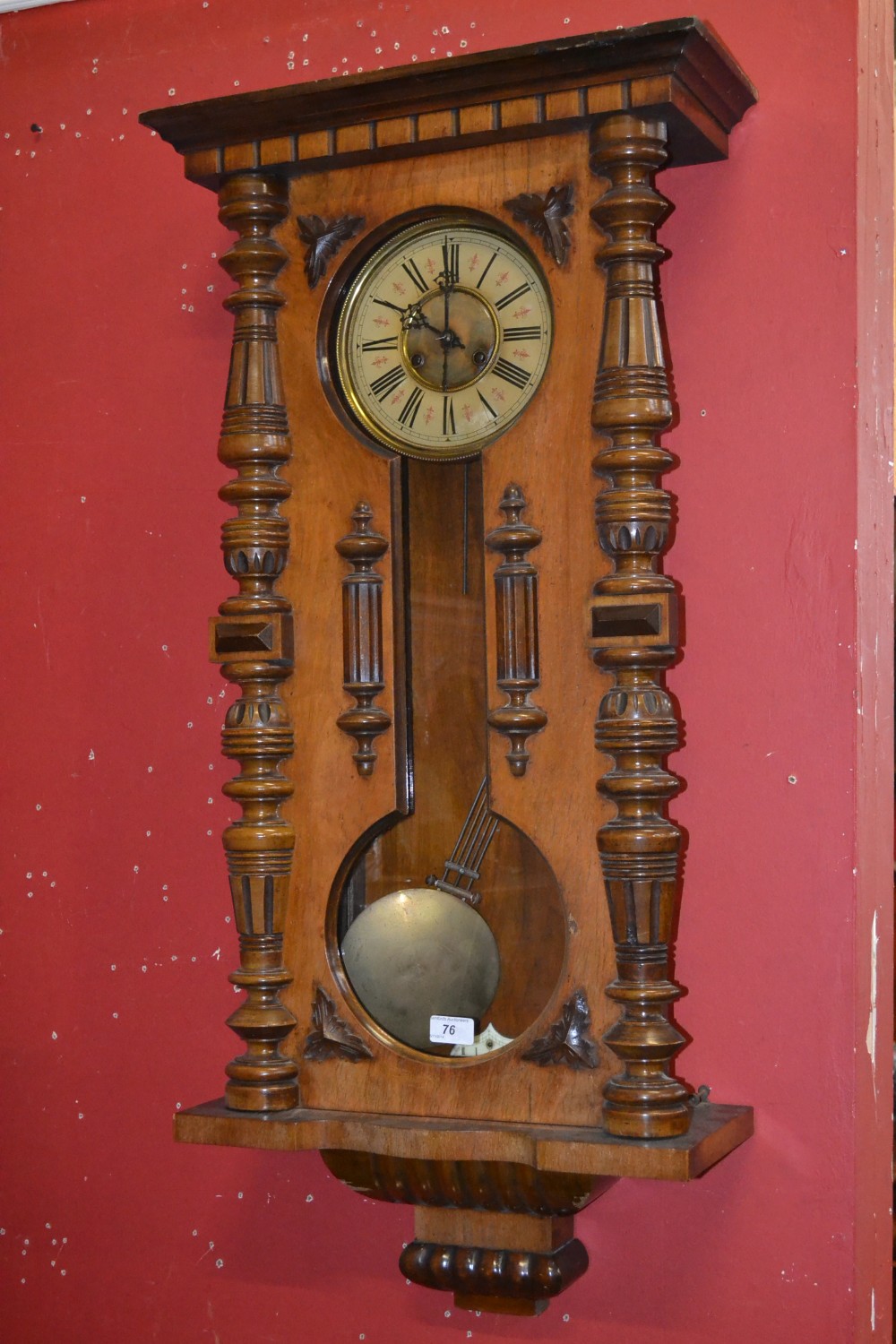 A German Vienna chiming wall clock, cream and gilt dial, Roman numerals, carved column front, marked