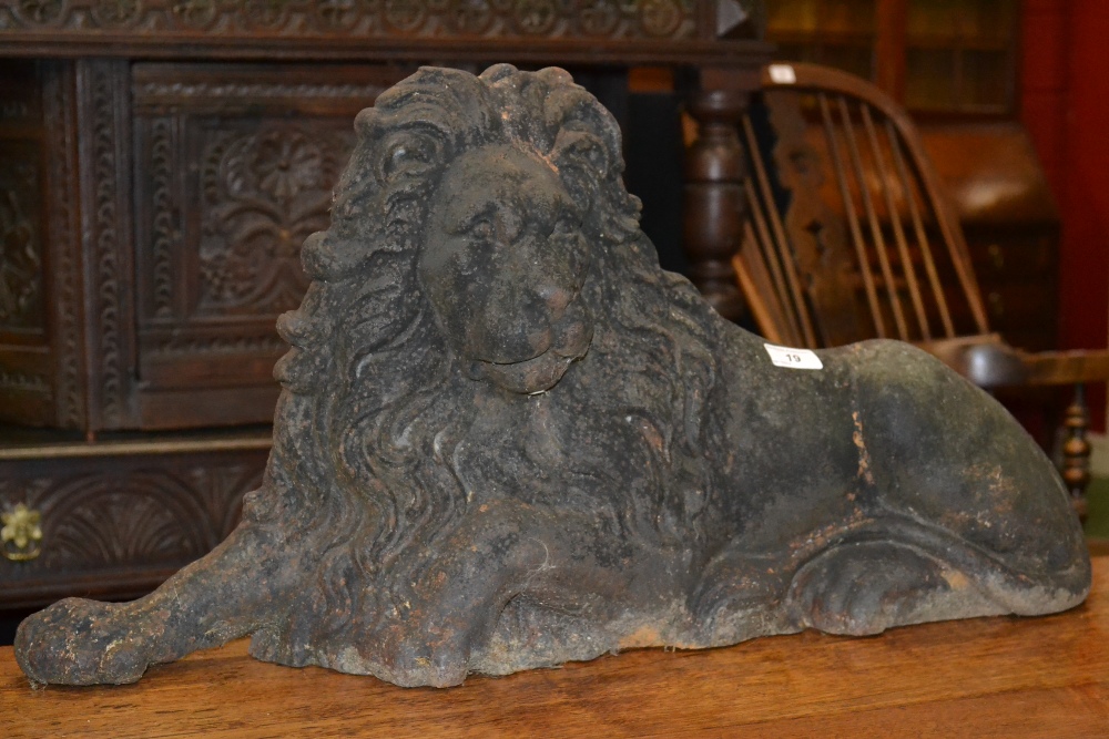 A cast iron fireguard, as a reclining lion