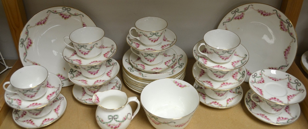 An Aynsley pink rose and ribbon swags tea service, pattern no.14059, including ten cups, saucers and