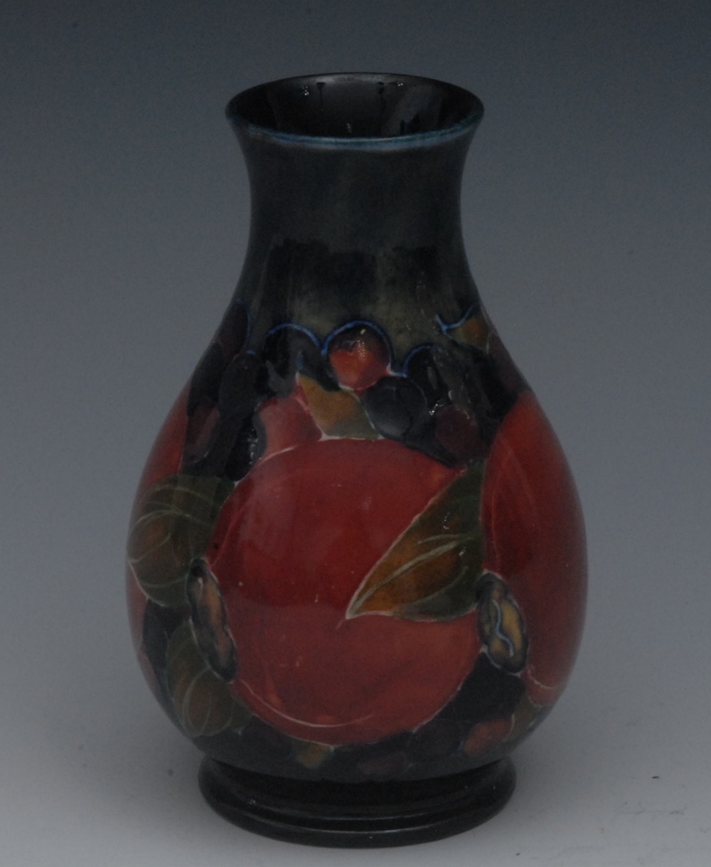 A Moorcroft Pomegranate pattern baluster vase, tube lined with berries and fruit, in tones of red,