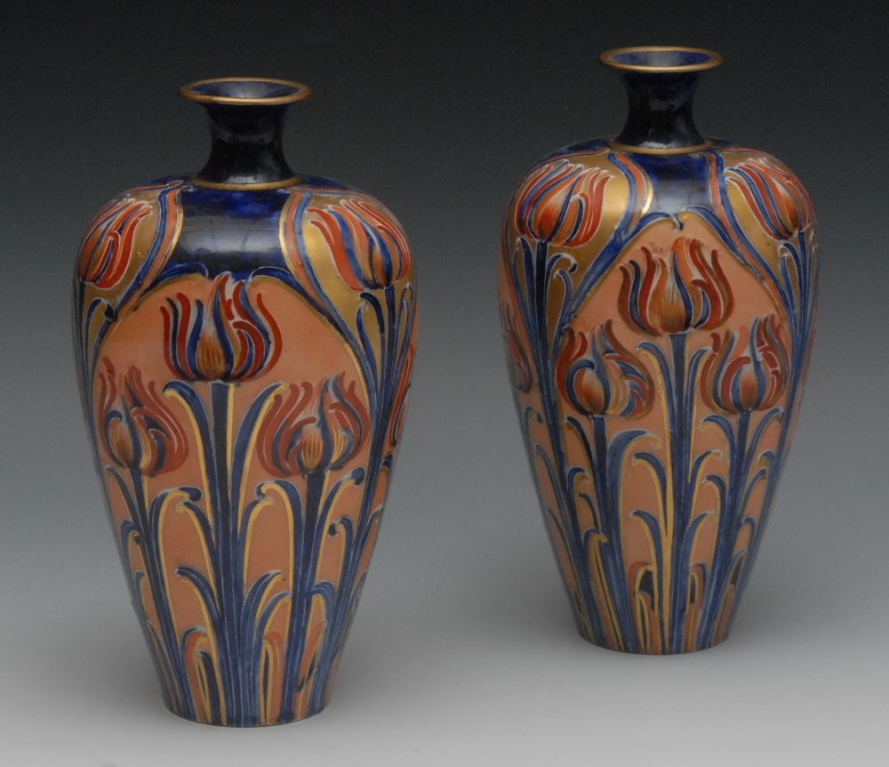 A pair of Moorcroft McIntyre ovoid vases, tube lined with tulips and foliage, in tones of red,