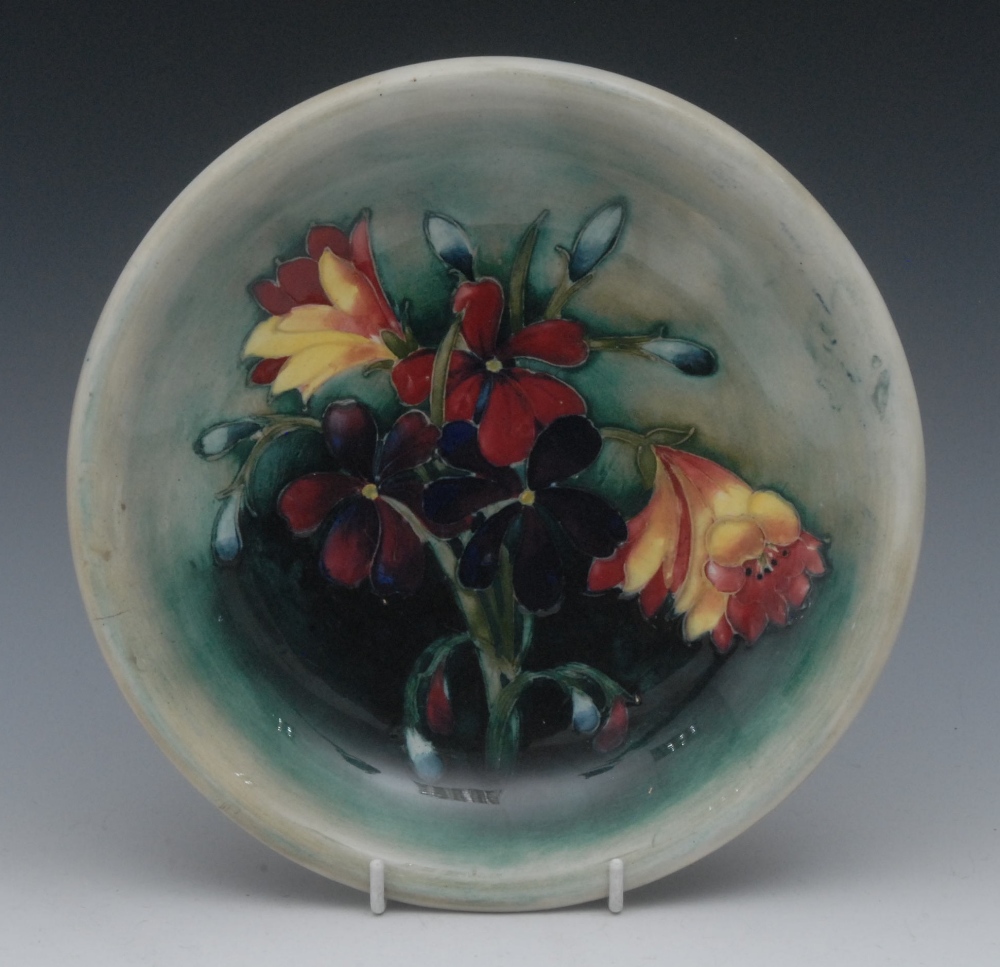A Moorcroft Spring Flowers pattern circular plate, tube lined with flowers and foliage, in colours