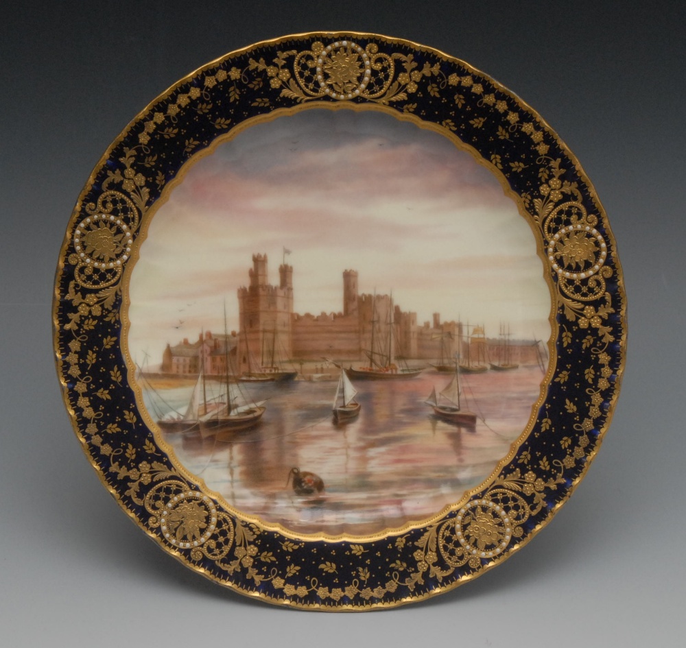A Derby Named View shaped circular Harrow plate, painted by Edwin Trowell, signed, with Caernarfon