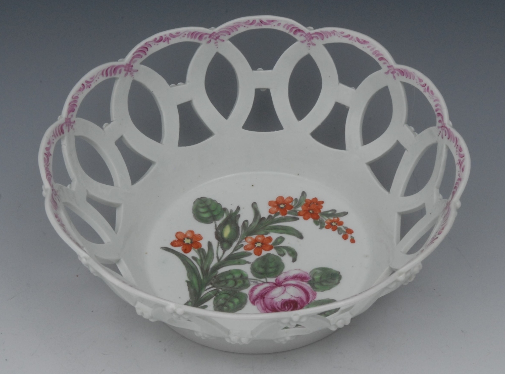A Worcester flared circular basket, the centre painted with rose and orange flowers, the exterior