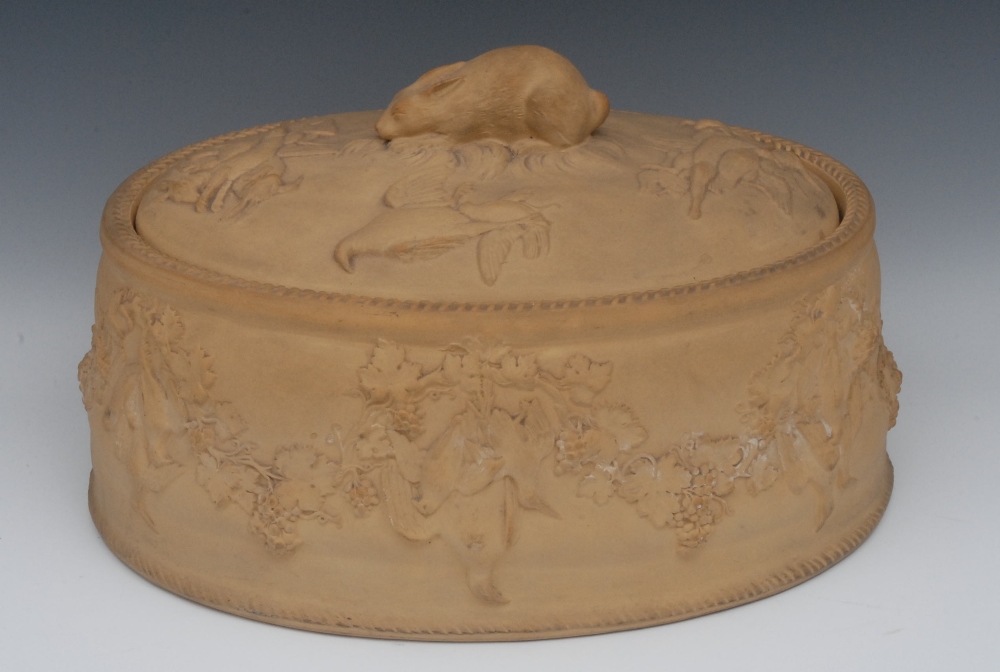 A Wedgwood caneware game pie dish, cover and liner, the cover in relief with ducks and hares, hare