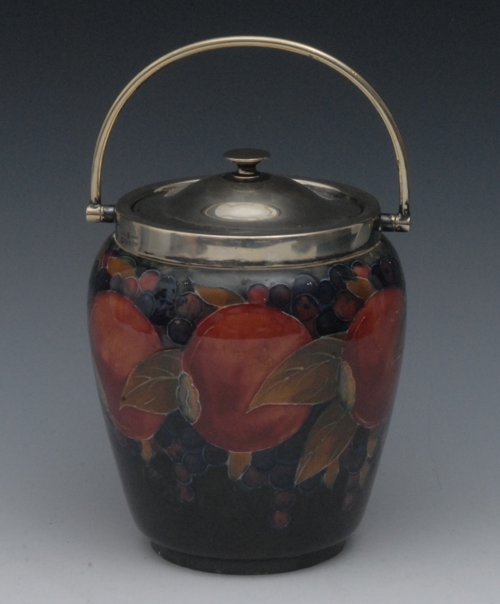 A Moorcroft Pomegranate pattern biscuit barrel, tube lined with berries and fruit, in tones of