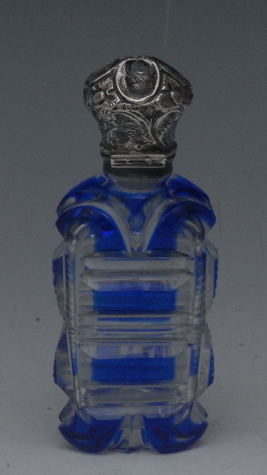 A 19th century silver coloured metal mounted cut clear and overlaid blue glass scent bottle,
