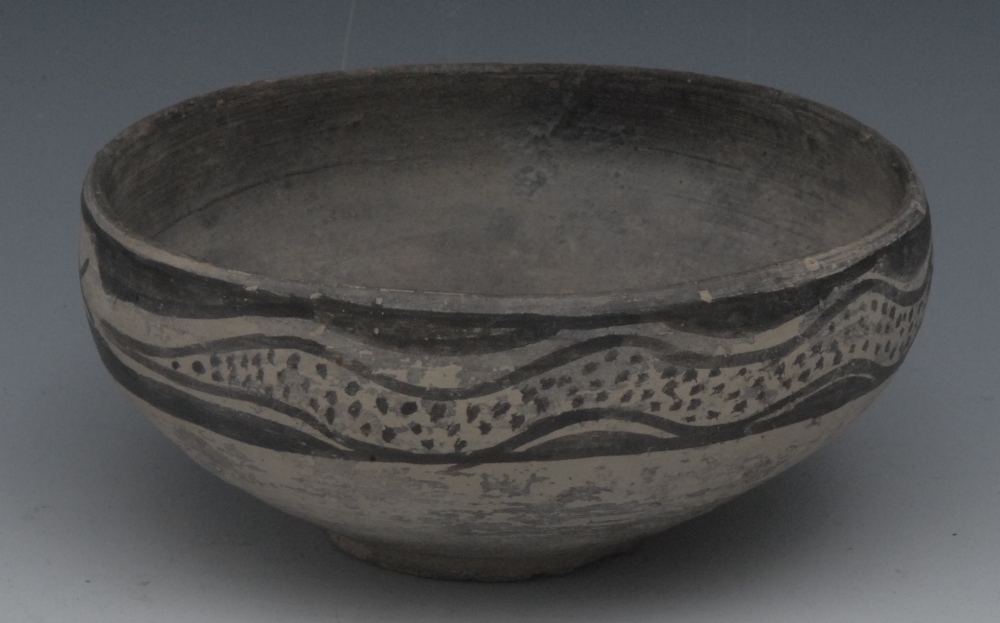 An Indus Valley circular bowl, decorated with undulating serpent, 15cm diam