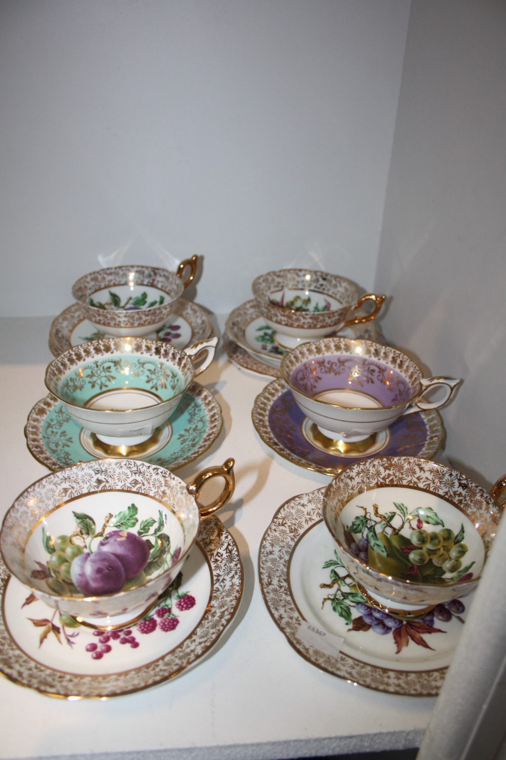 Teaware - a Royal Stafford teacup and saucer, decorated with roses and ornately gilded; another;