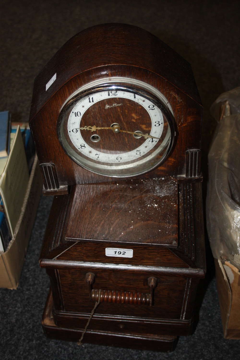 An Edwardian oak mantel clock; a cased singer sewing machine