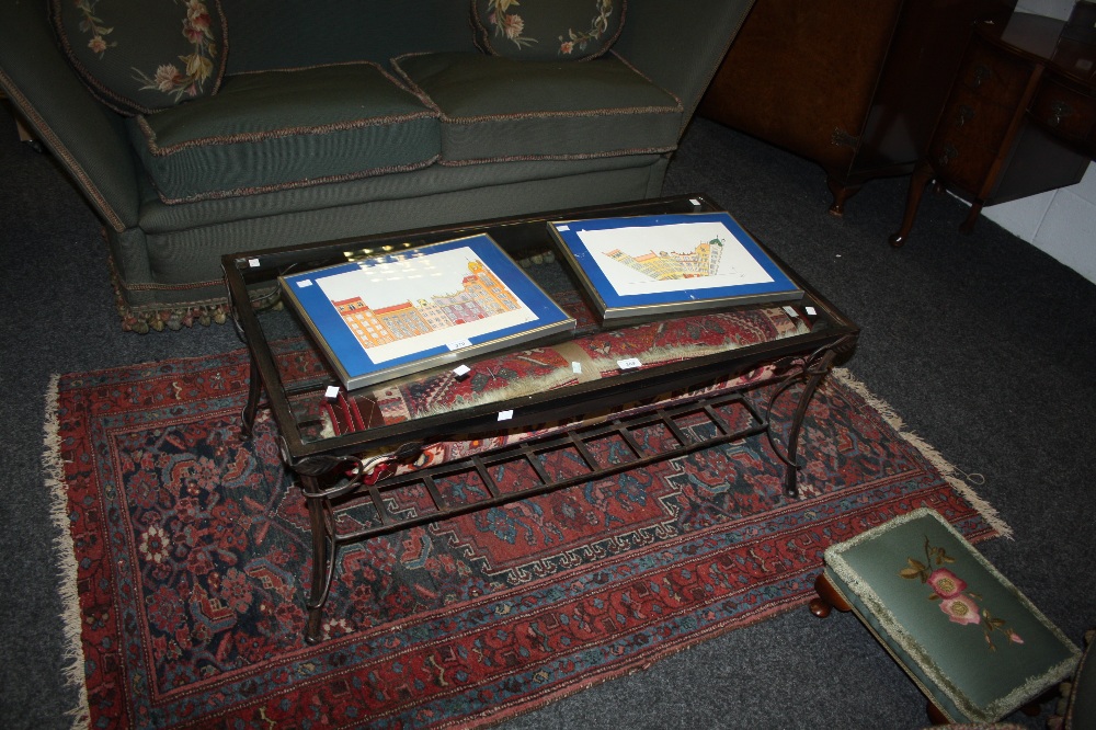 A contemporary iron coffee table with glass top