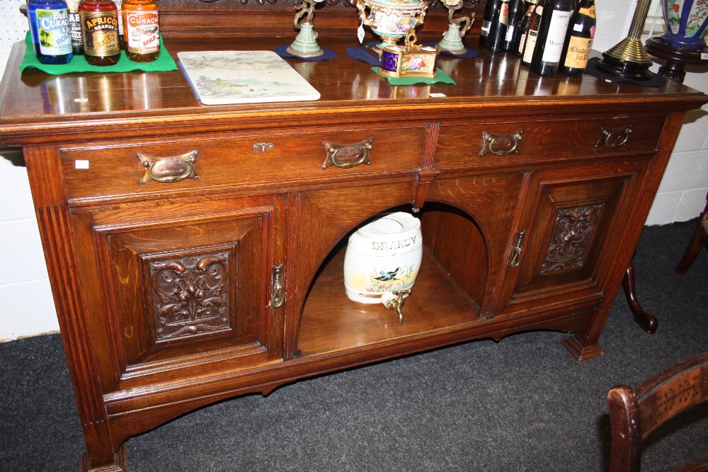 A Victorian oak sideboard, carved gallery, with dental cornice, above carved frieze of swags and