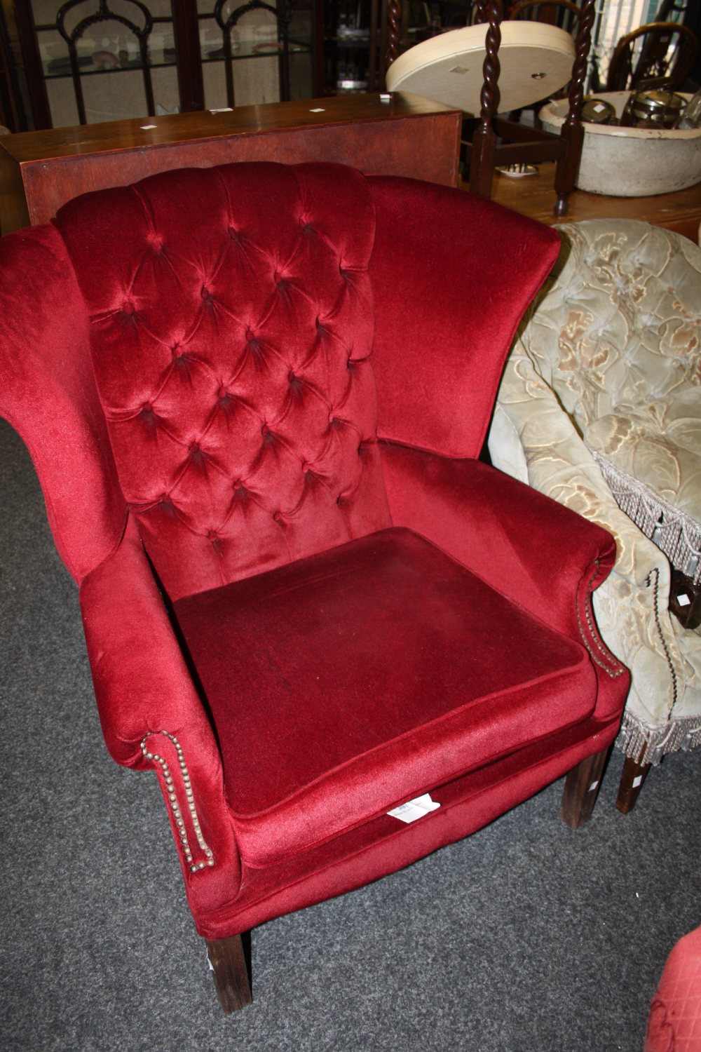 An Edwardian fireside chair, square tapering leg, upholstered in red