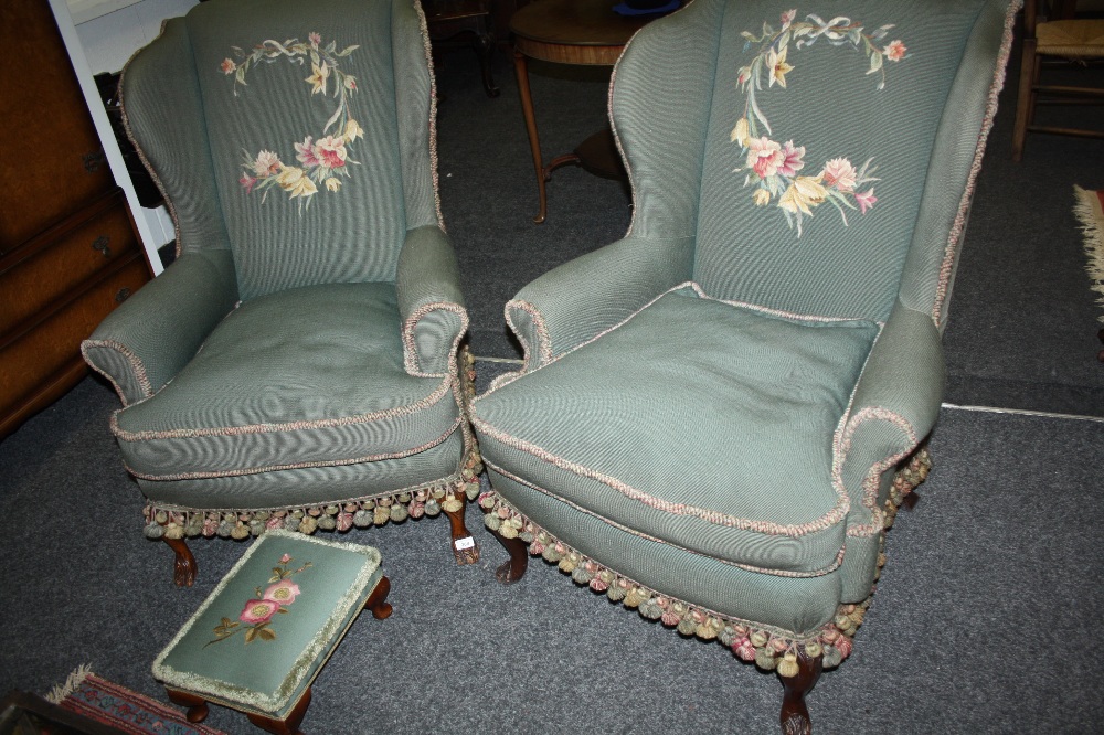 A pair of early 20th century wingback armchairs, cabriole legs; conforming footstool