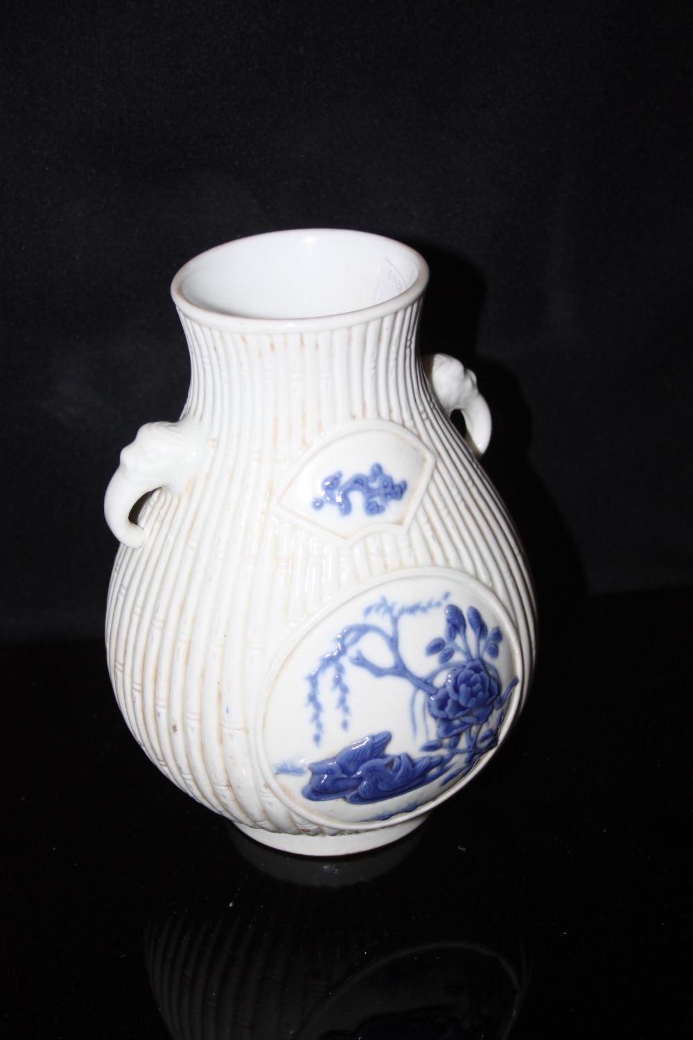 A Chinese vase, elephant head handles, the body decorated with stylised bamboo, impressed marks