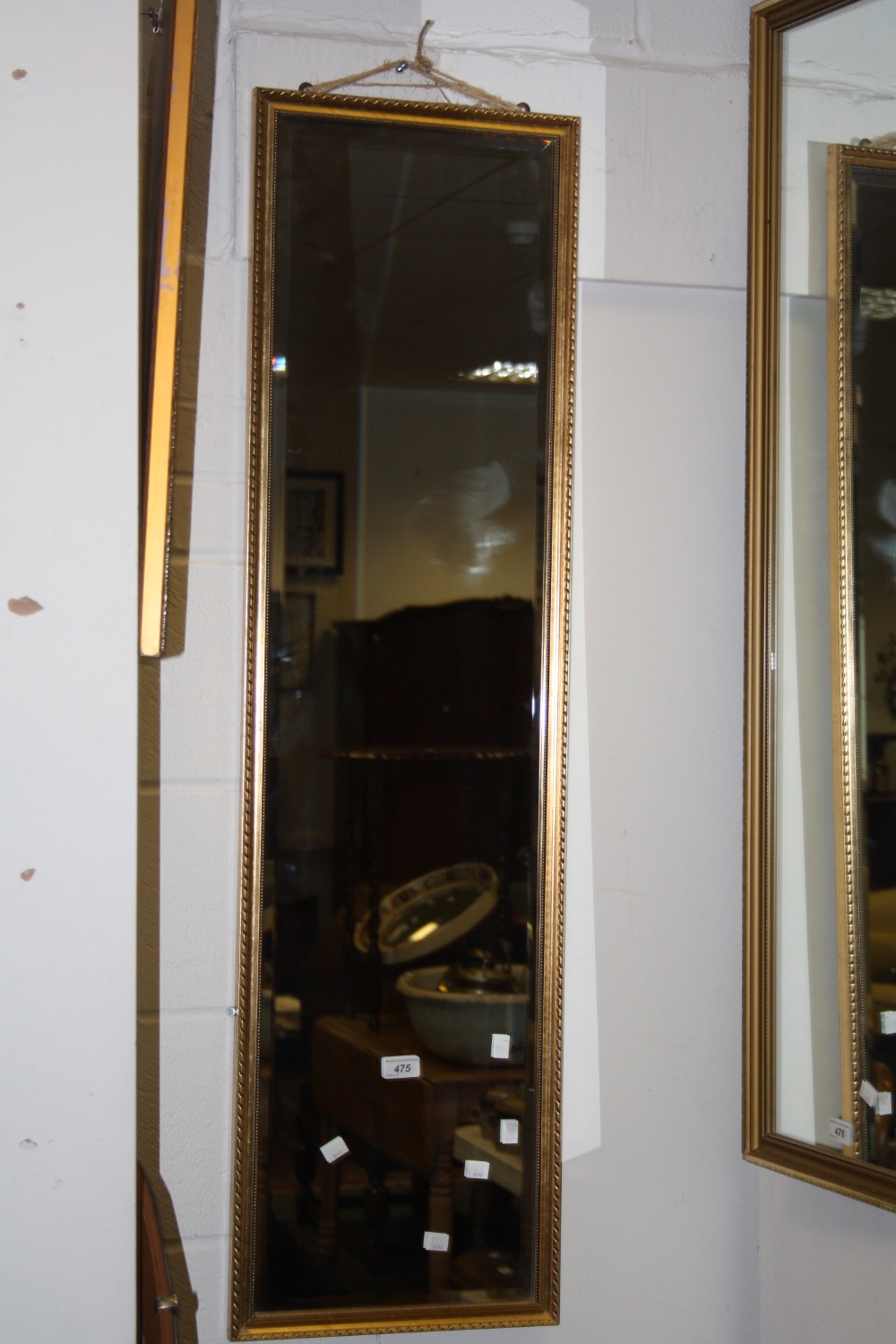 A gilt rectangular hall mirror;  a bevelled circular mirror;  etc (3)