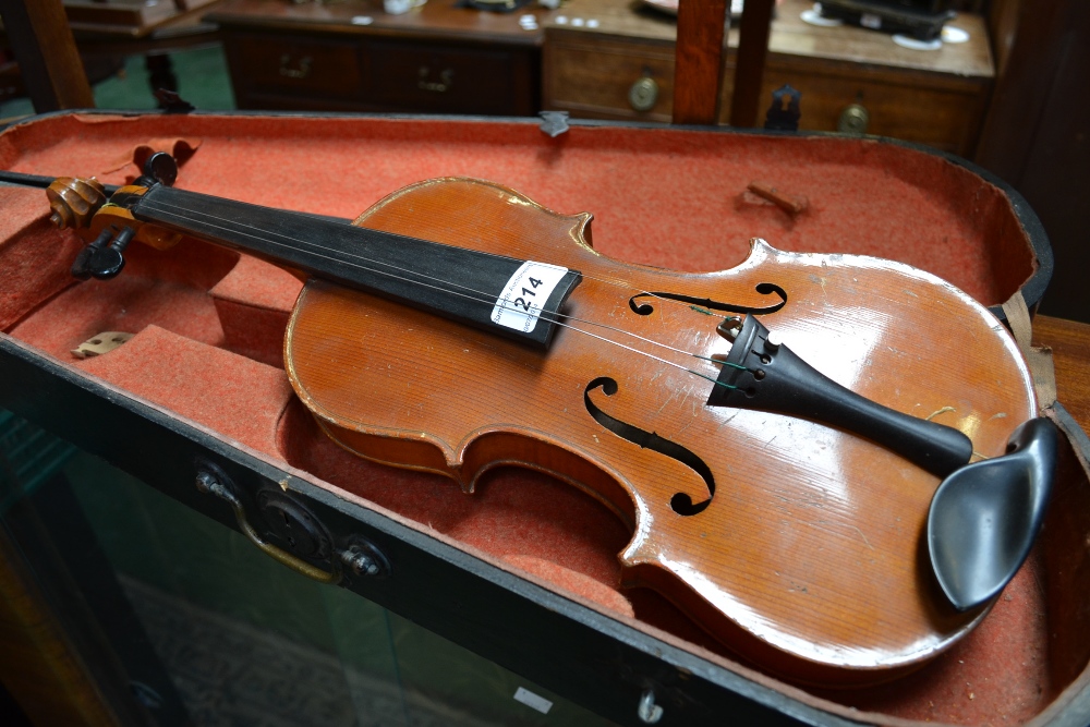 A violin, the two-piece back 33.75cm long excluding button, ebonised tuning pegs, outlined