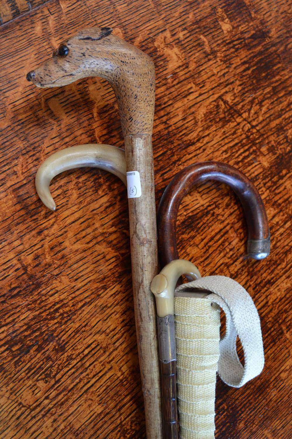 A walking cane with greyhound handle; walking cane with silver collar; others (5)