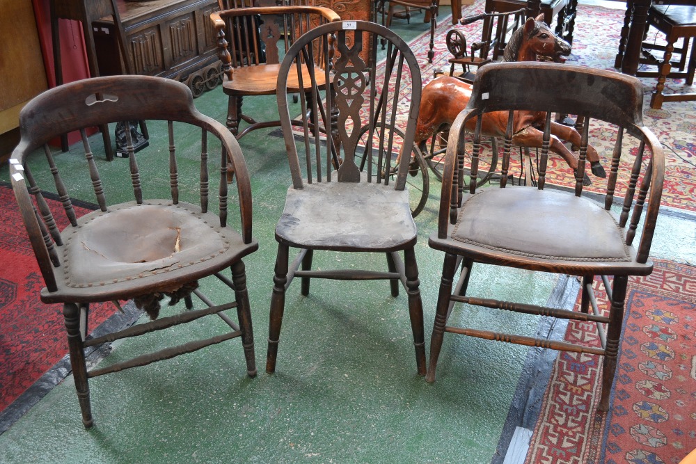 Two oak spindle back tub chairs and a wheel back dining chair (3)