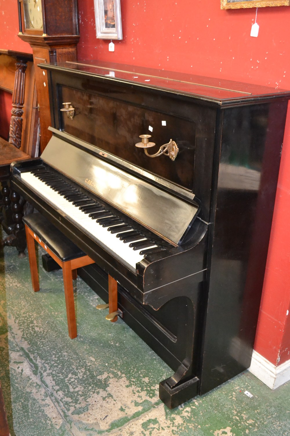 An upright piano with brass candle sconces, C.Bechstein