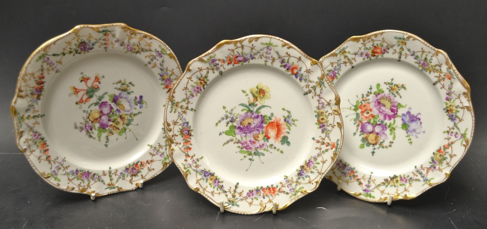 A trio of Dresden cabinet plates, centrally painted with flowers, gilt swags border, 19th century