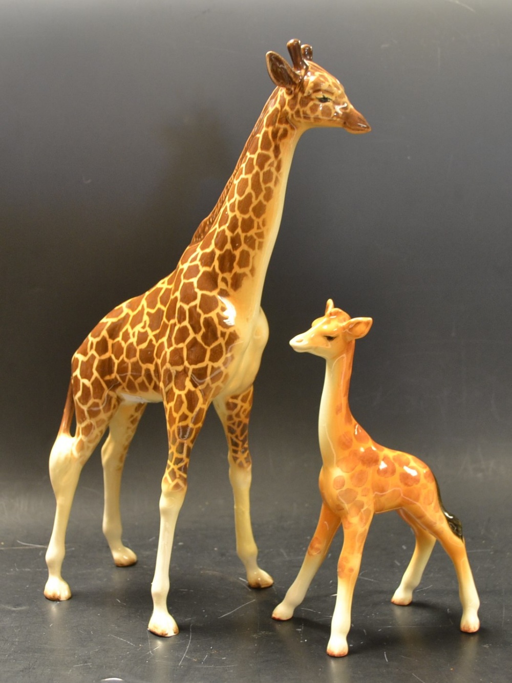 A Beswick giraffe; another, giraffe calf (2)