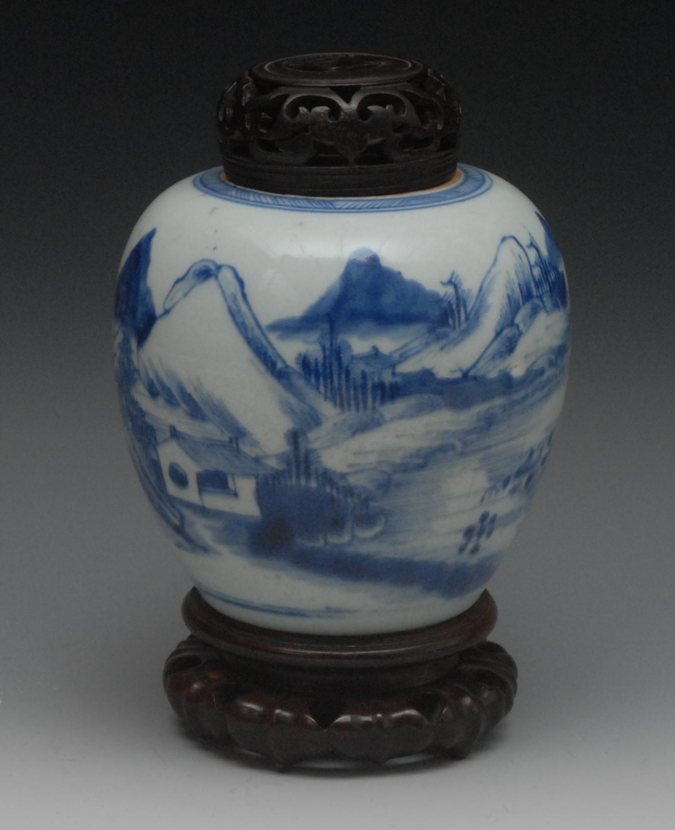 An 18th century Chinese ovoid ginger jar, painted in underglaze blue with mountains and huts,