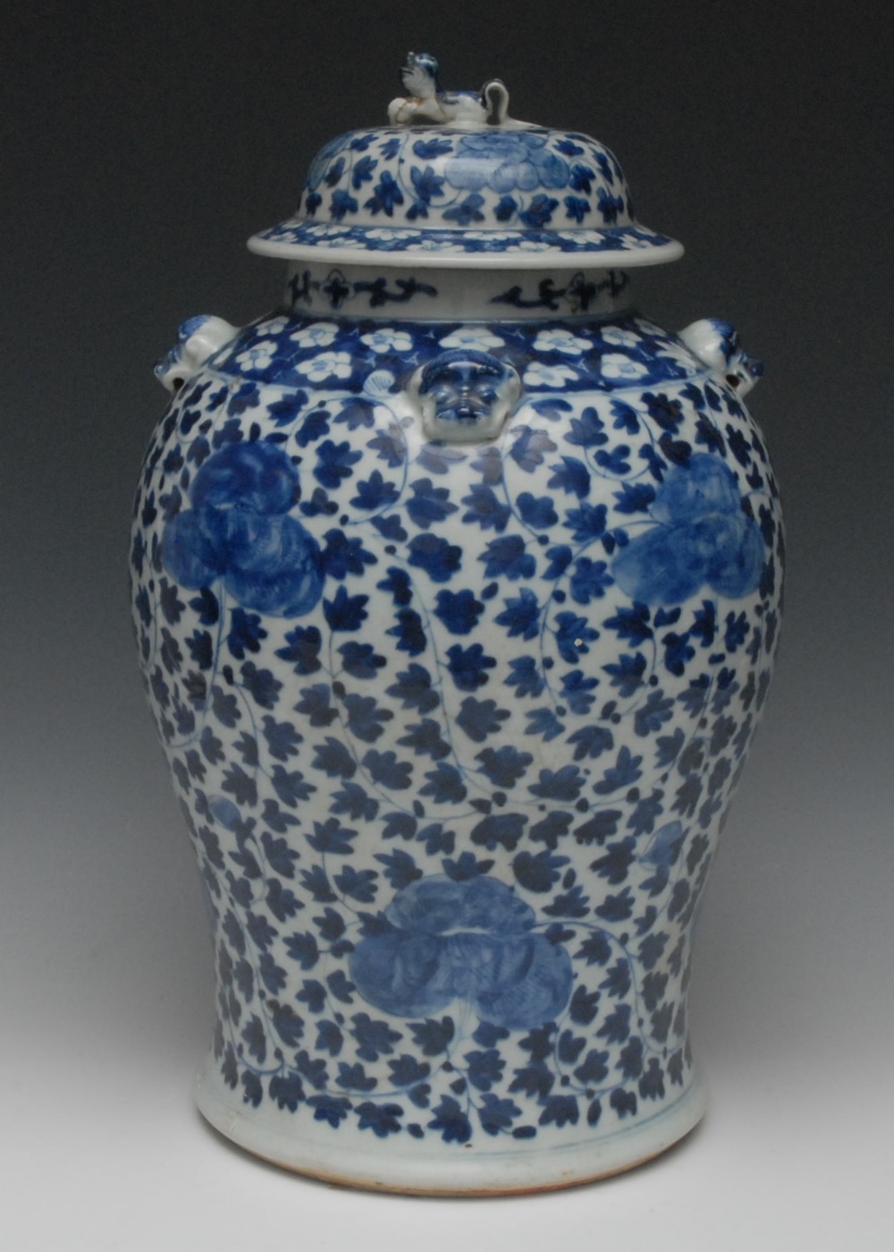 A Chinese porcelain baluster jar and cover, decorated in underglaze blue with stylized flora, lion