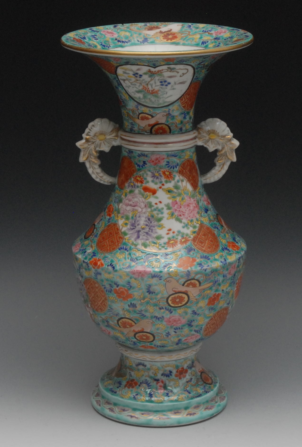 A Chinese Famille Verte vase, of shouldered ovoid form, decorated overall with mons, flowerheads and