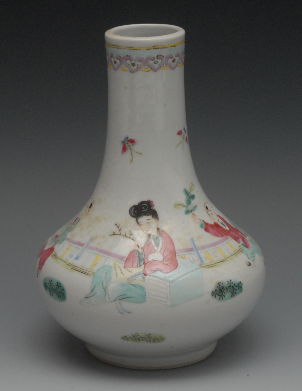 A Chinese Famille Rose bottle vase, painted with oriental figure and boy attendant, 18cm high