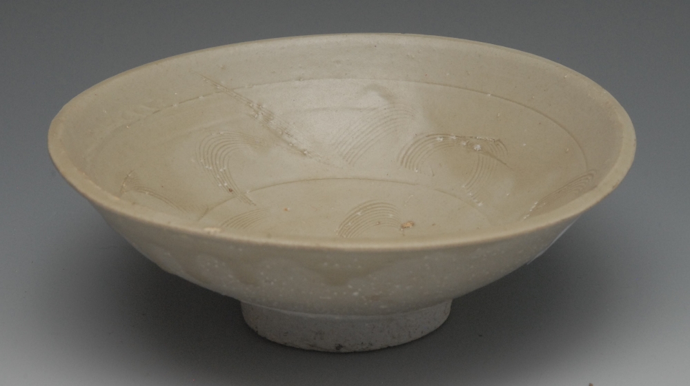 A Chinese celedon bowl, incised, 15cm diam, in the Sung manner but later