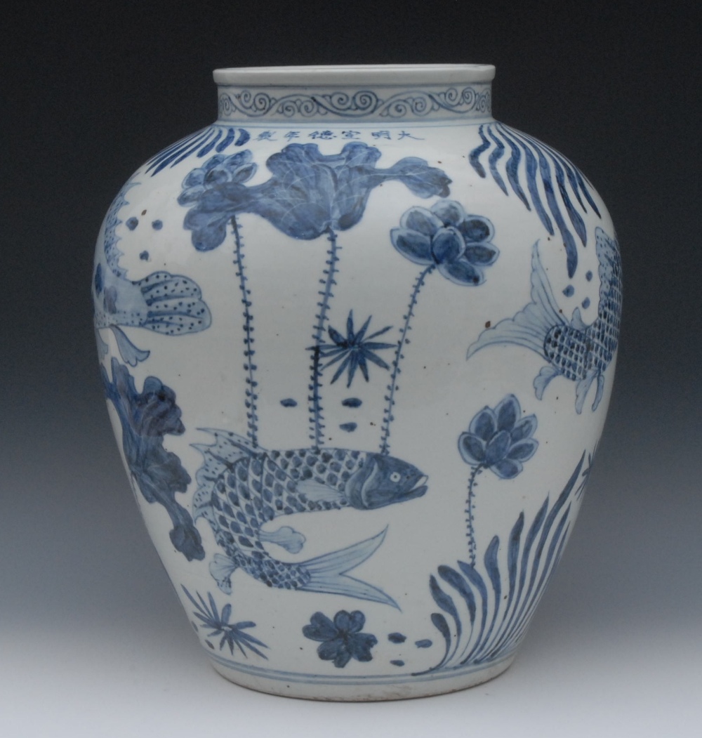 A large Ming blue and white ovoid vase, painted in vibrant tones of cobalt blue with five fish, each