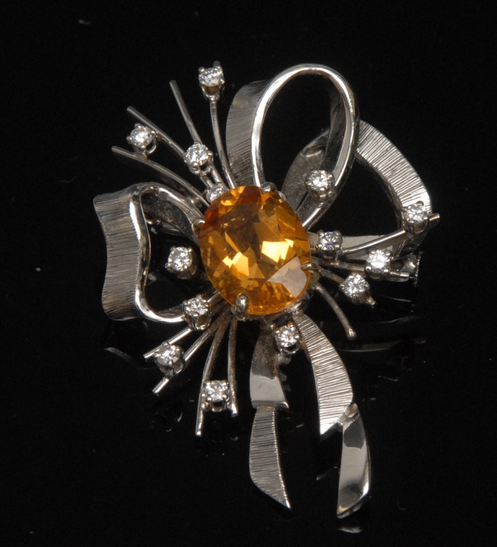 A diamond and citrine ribbon spray brooch, central oval citrine, approx 4.75ct, raised four claw