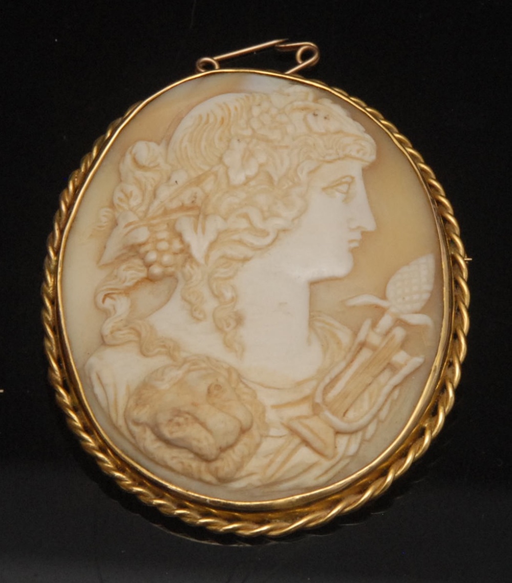 A 19th century shell cameo brooch, portrait of Baccante with a lion, grapes,spear, rope twist gold